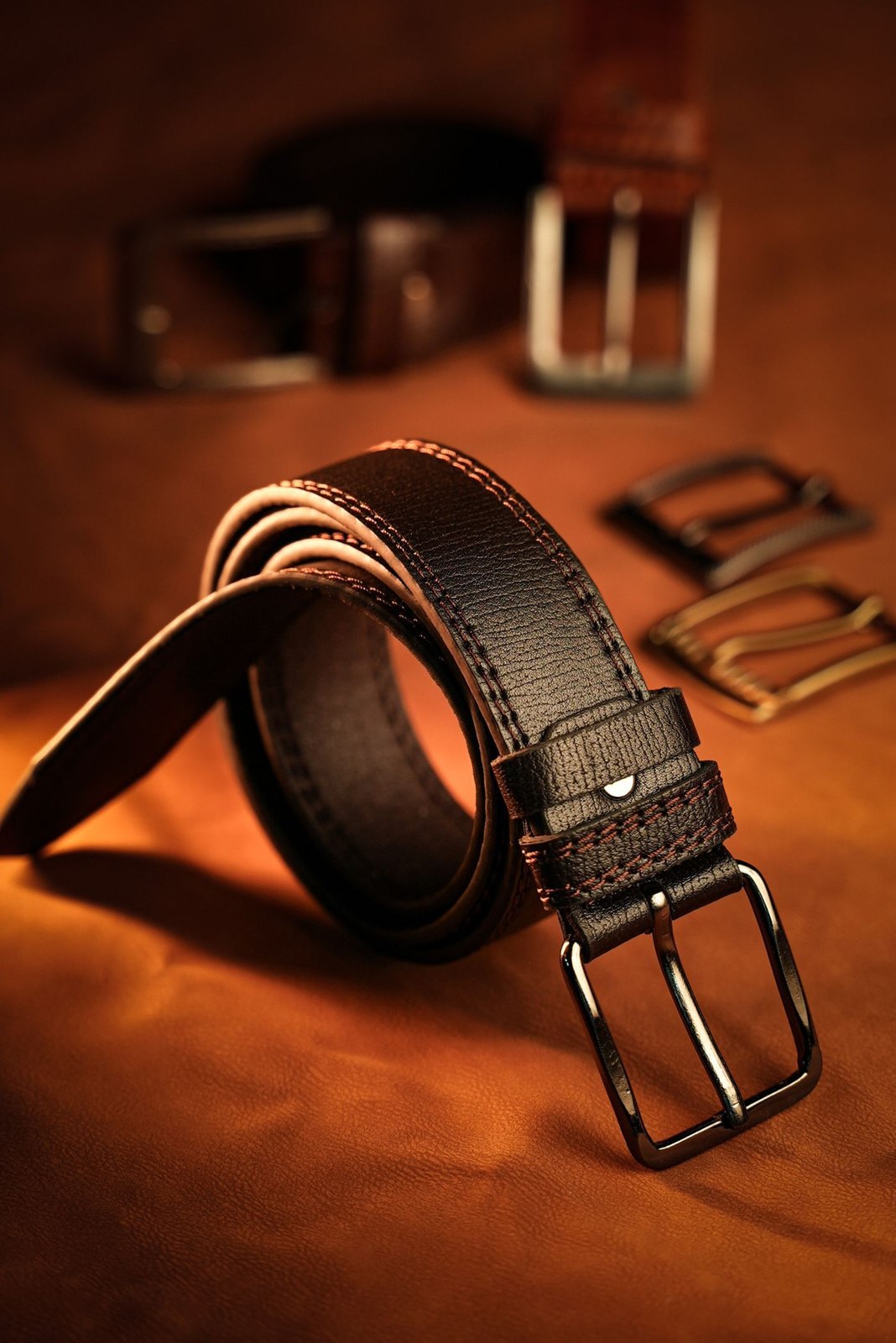 A brown leather belt with a simple buckle