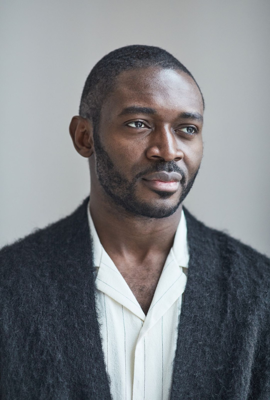 Dark cardigan over an open-collar shirt