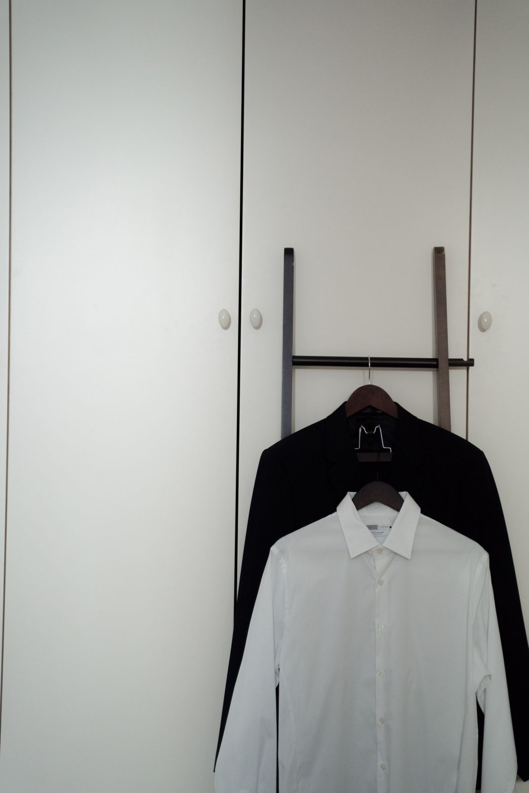 A white shirt and dark jacket hanging together