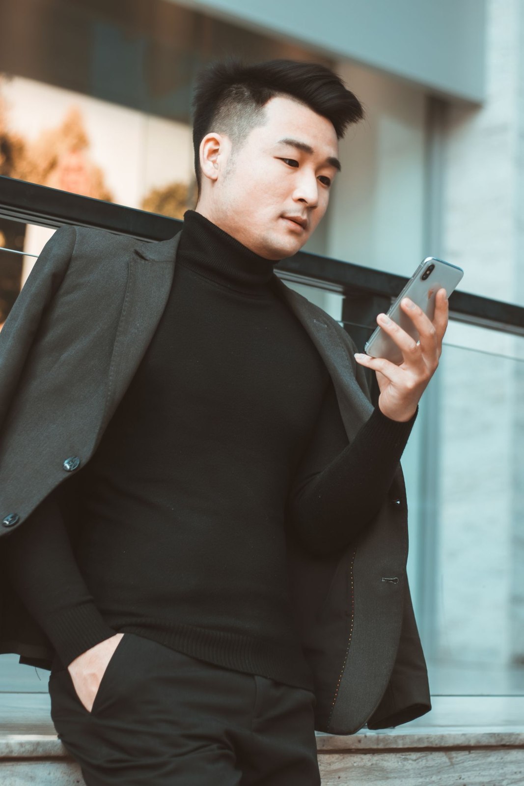 A tailored jacket carried over a shoulder