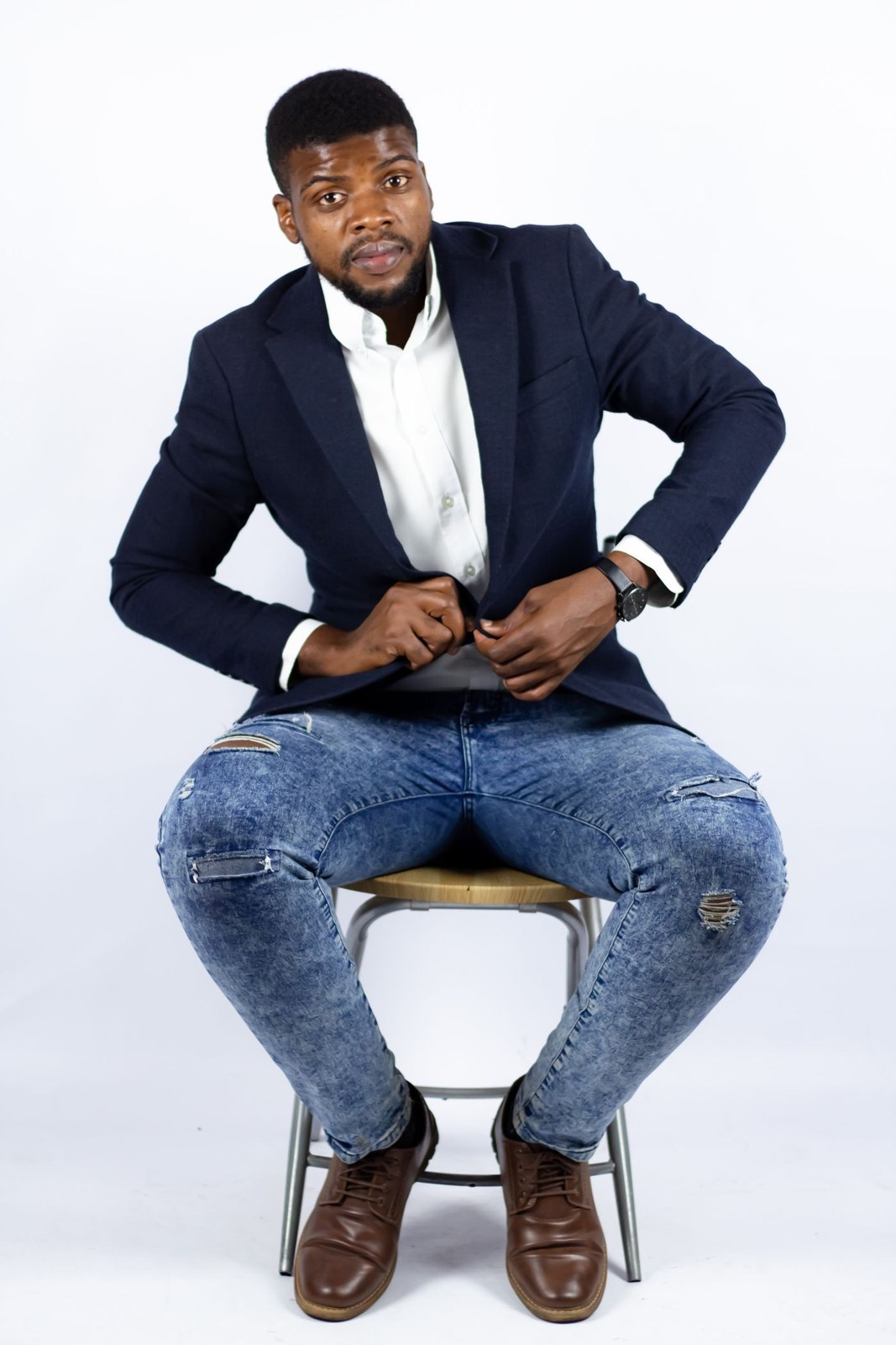 A navy blazer worn with pale blue denim