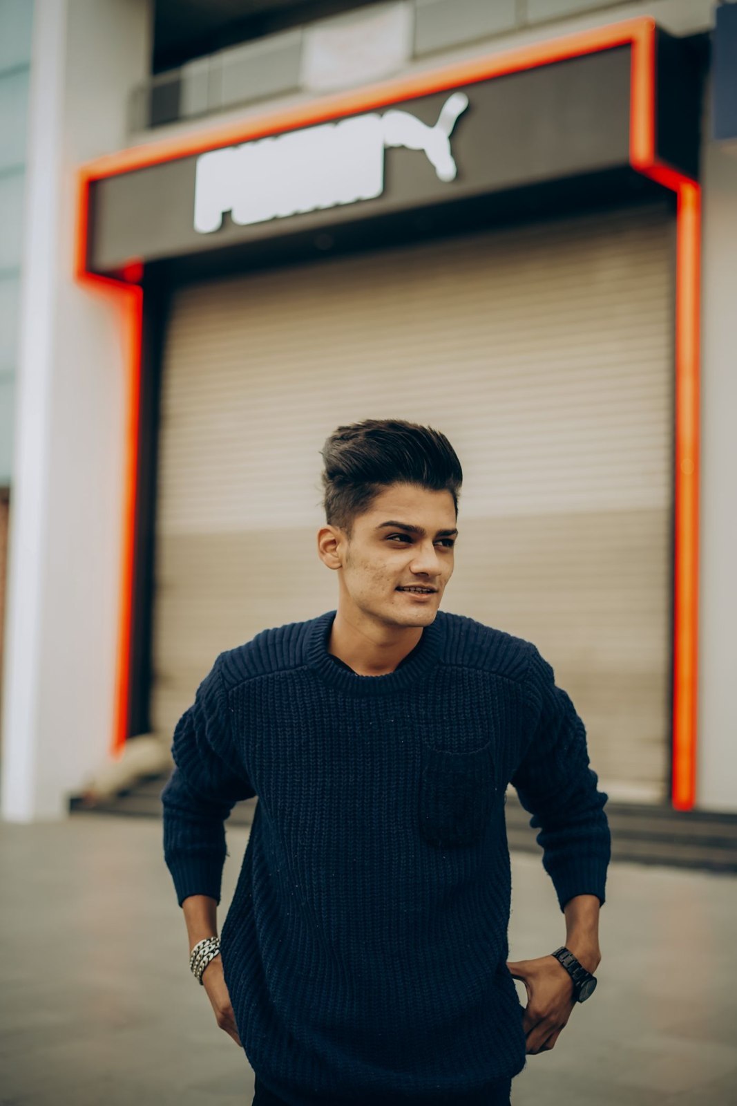 A navy crew-neck jumper outdoors