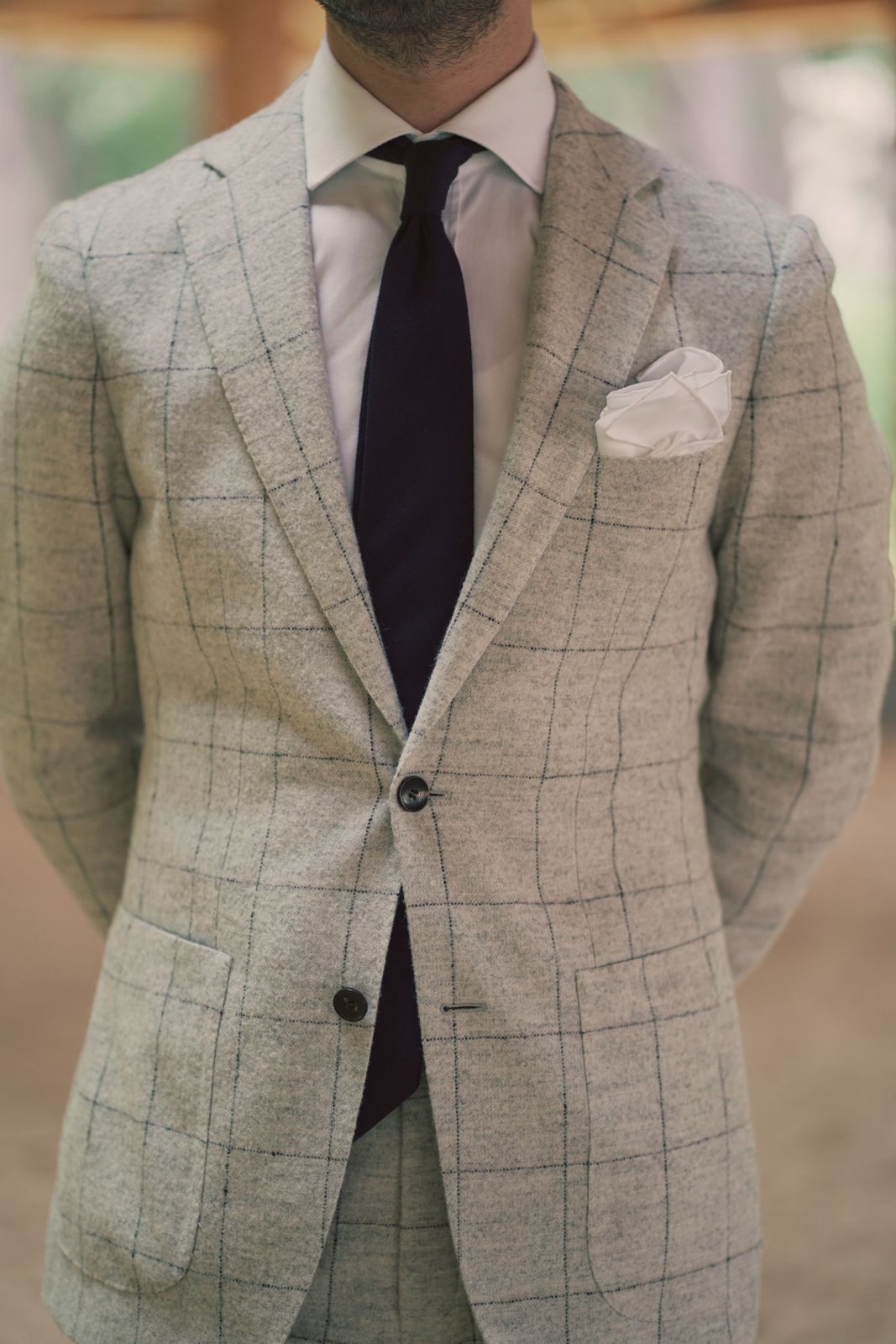 A pale pocket square in a checked jacket