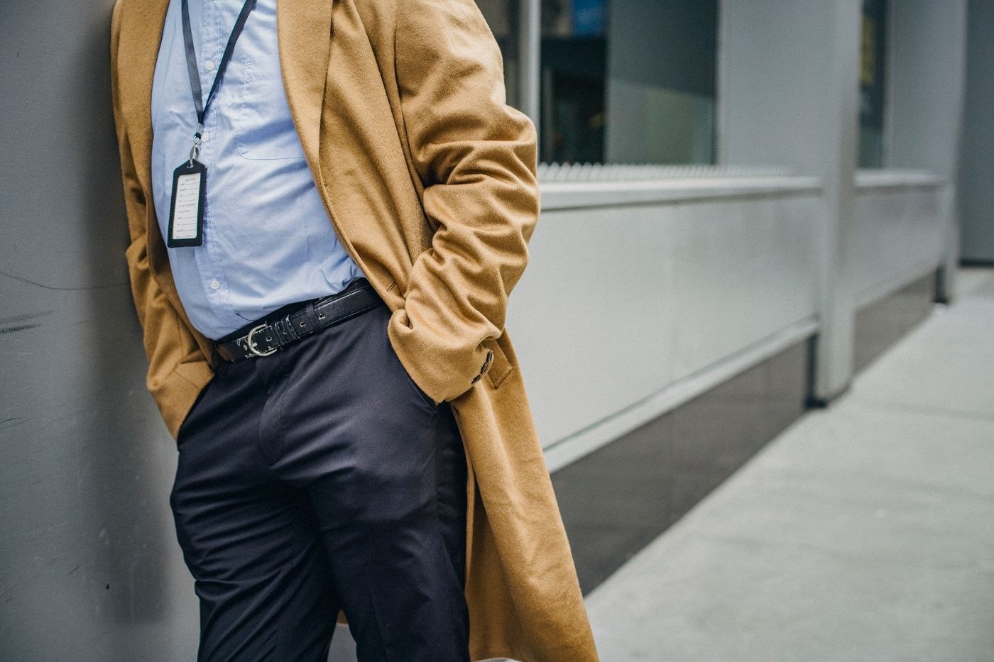 A long tan coat worn over a shirt