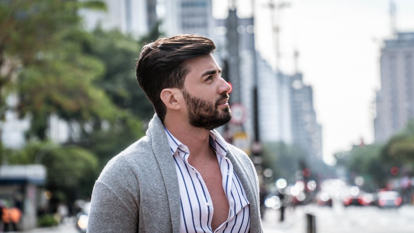 Open cardigan over a striped shirt