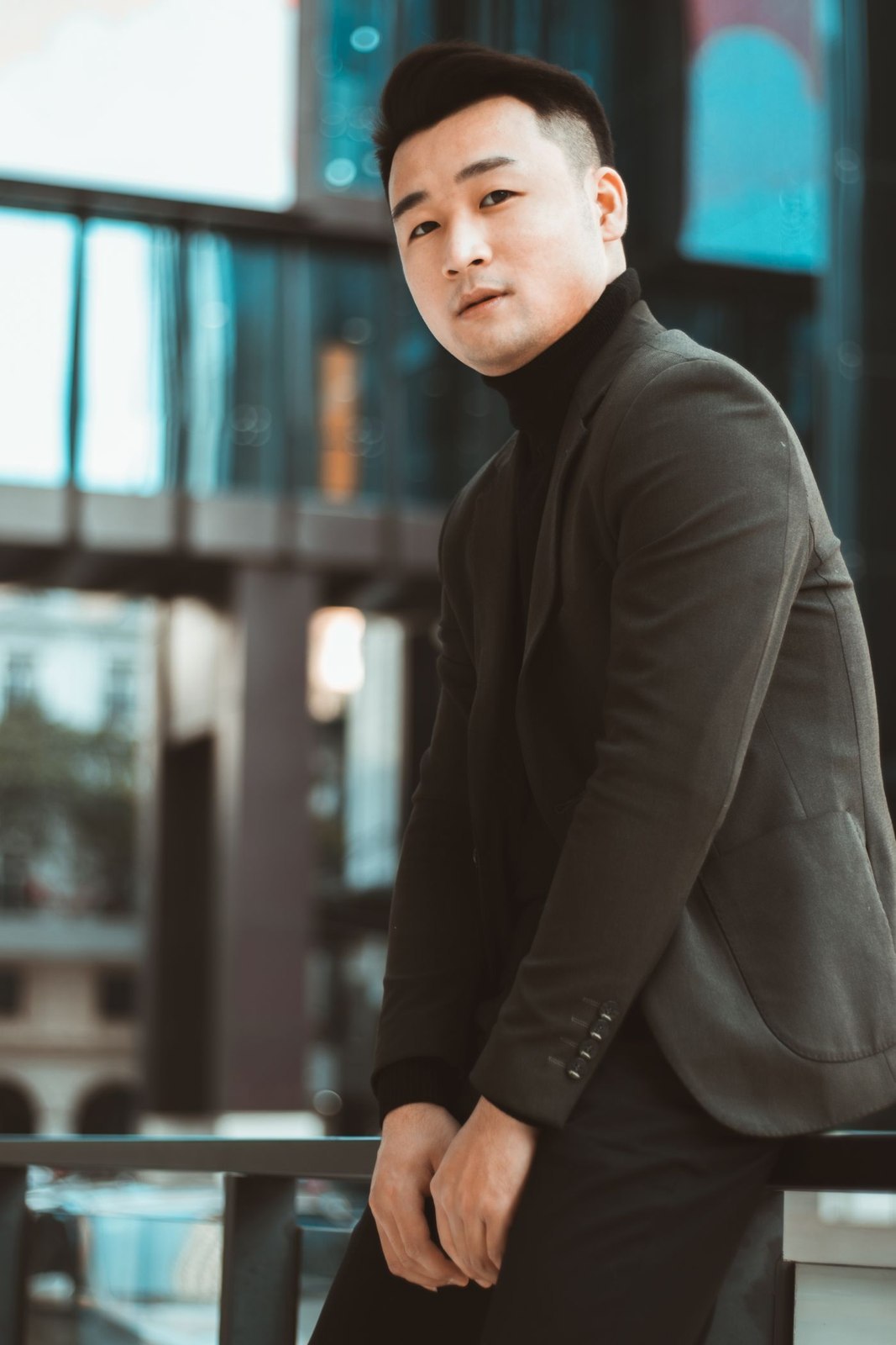 A dark roll-neck beneath a brown blazer