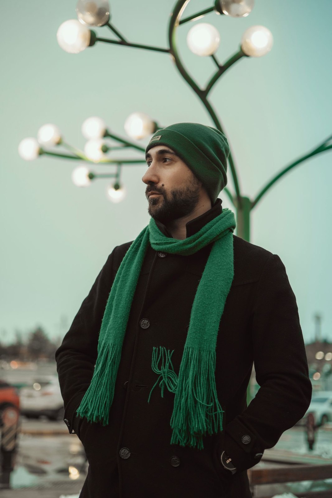 A long green scarf worn with a dark coat
