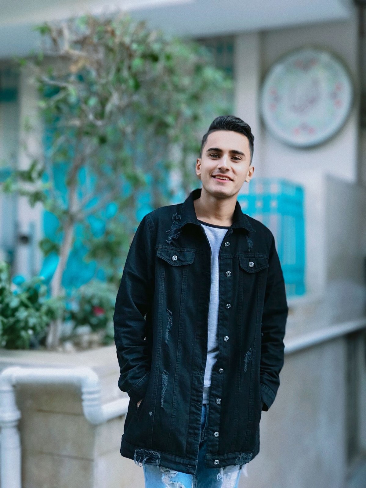 A dark denim jacket worn over a T-shirt