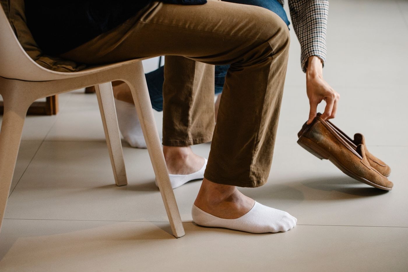 Putting on brown loafers with casual trousers