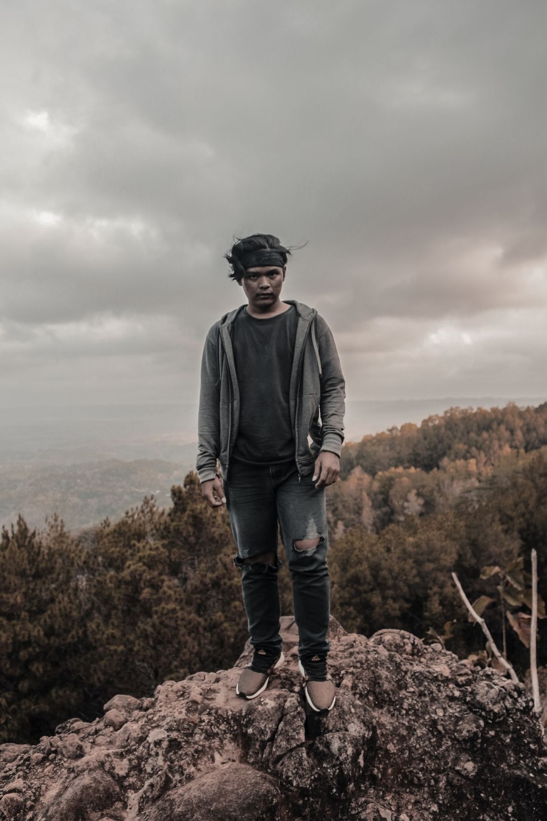 A tonal dark outfit in an outdoor setting