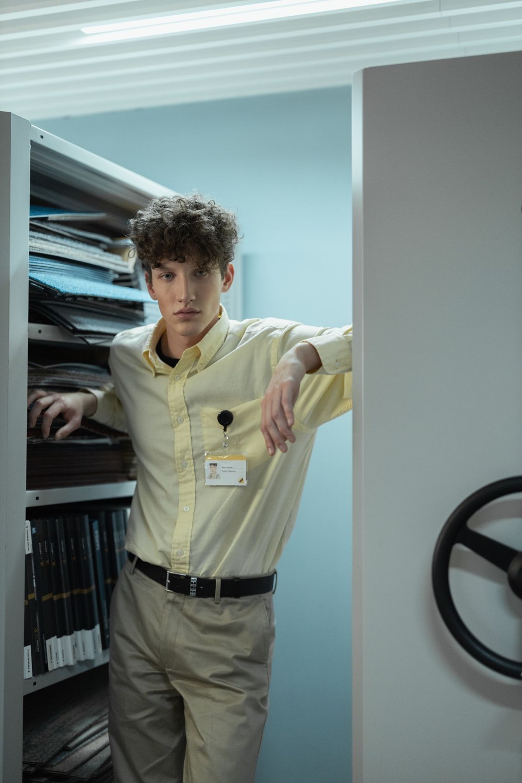 A pale polo tucked into light office trousers