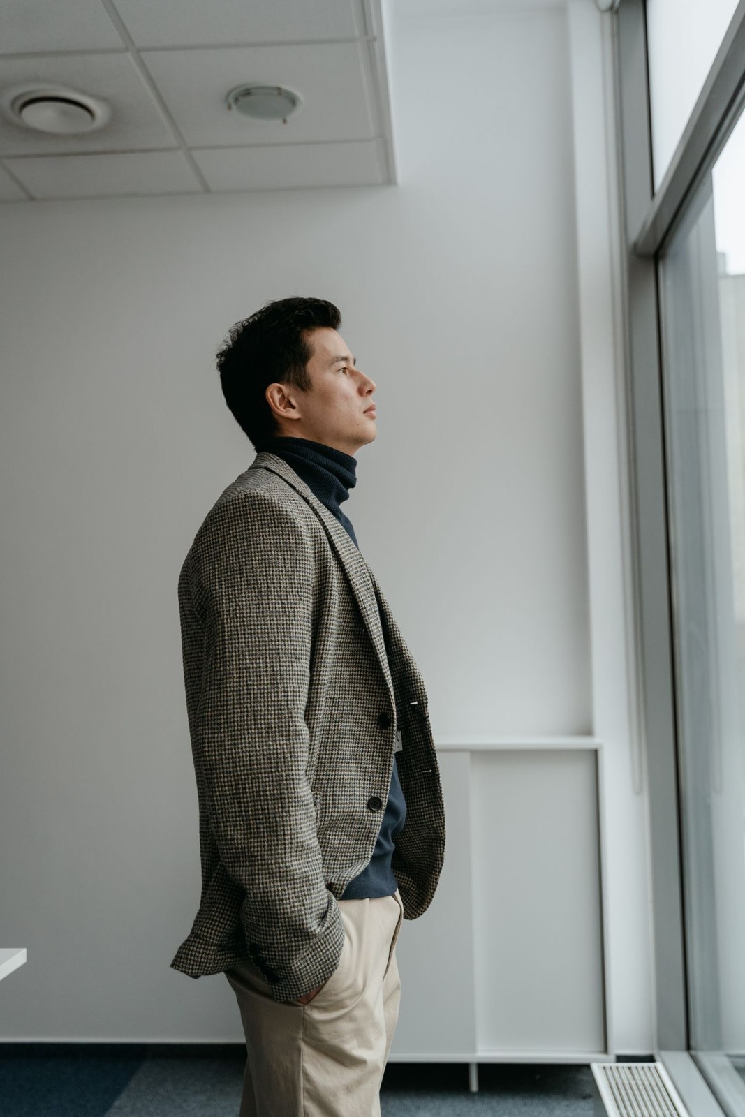 A textured jacket over a dark roll-neck