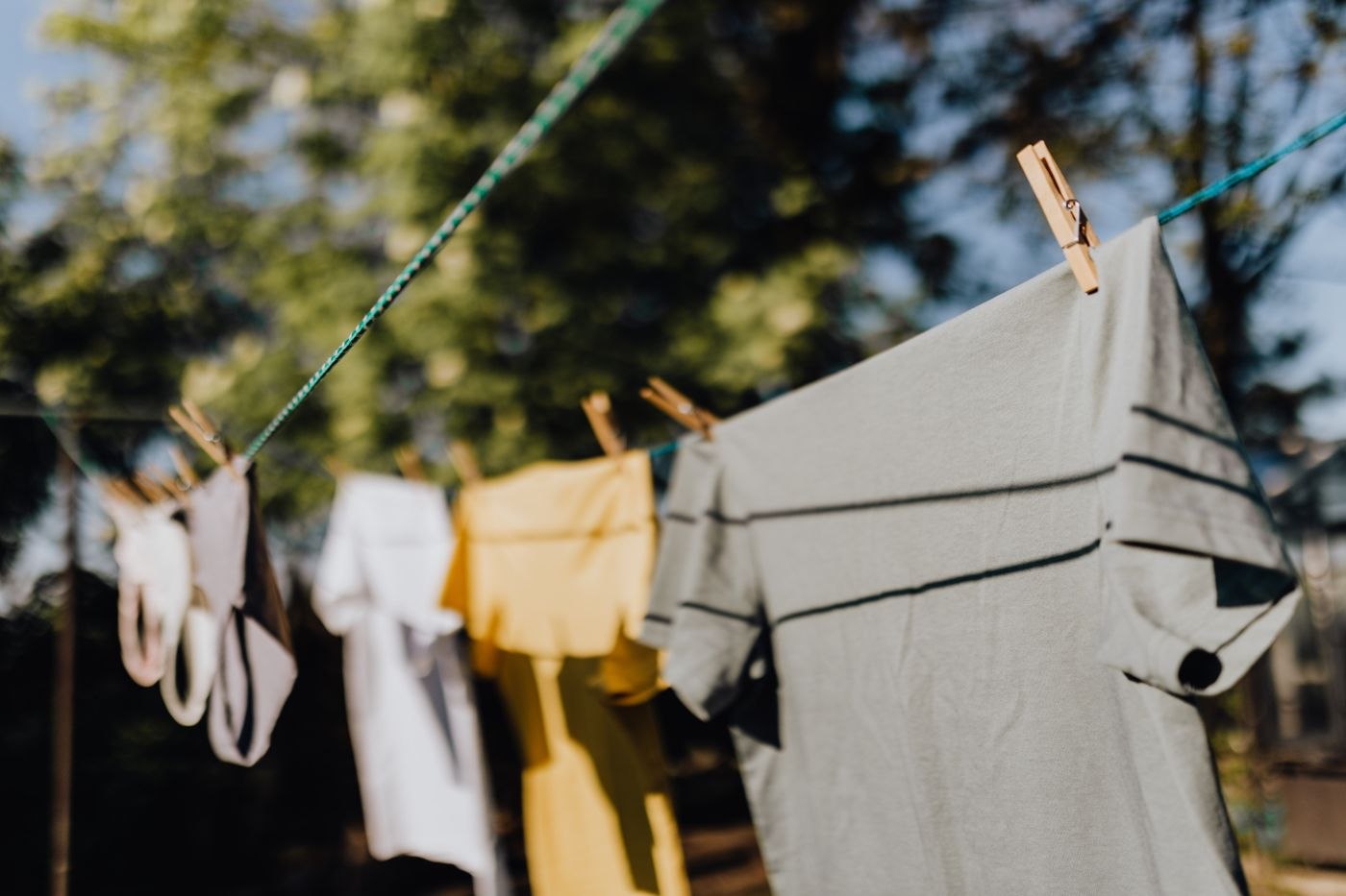 Shirts drying on a washing line outdoors