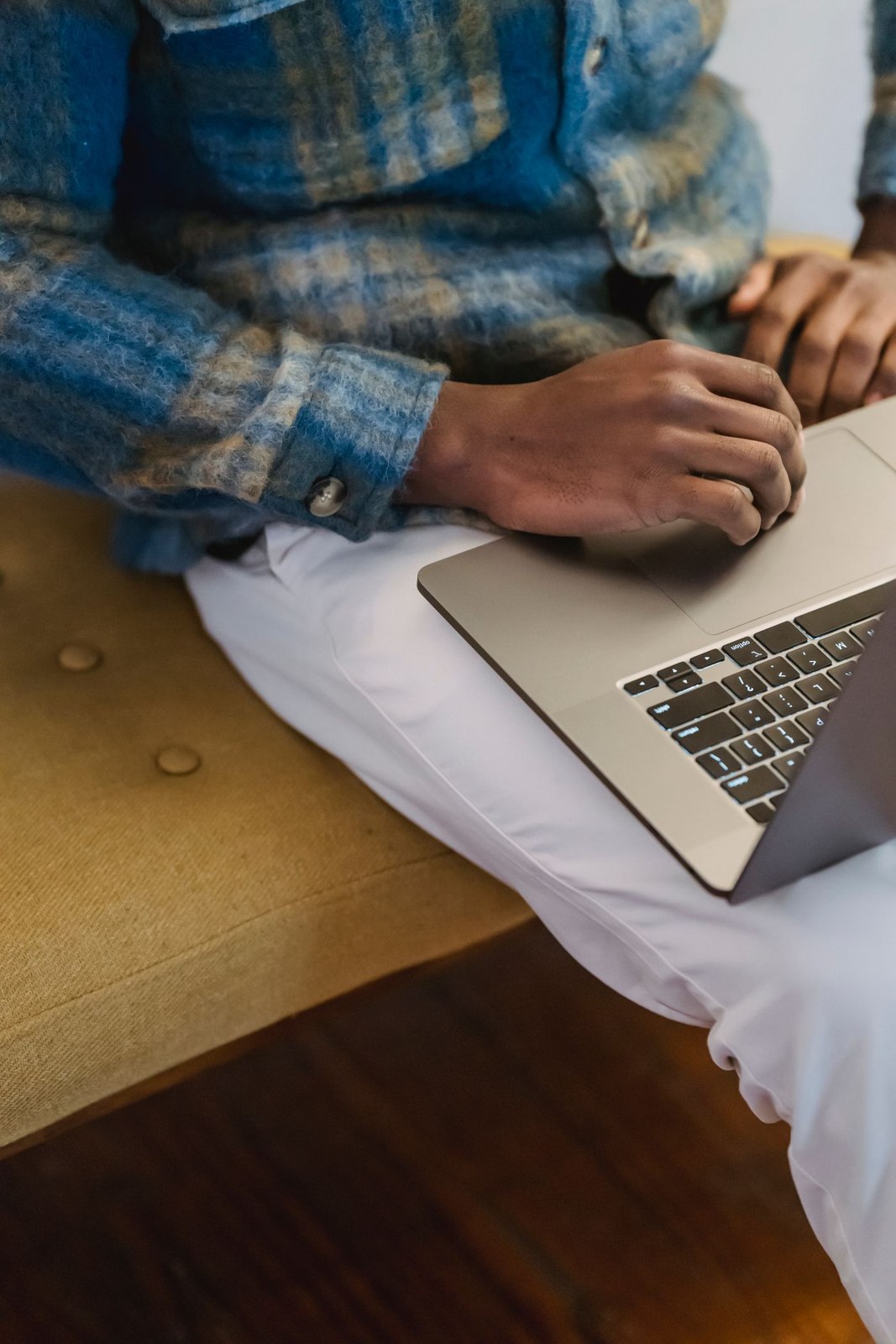 A checked shirt and light trousers at a desk