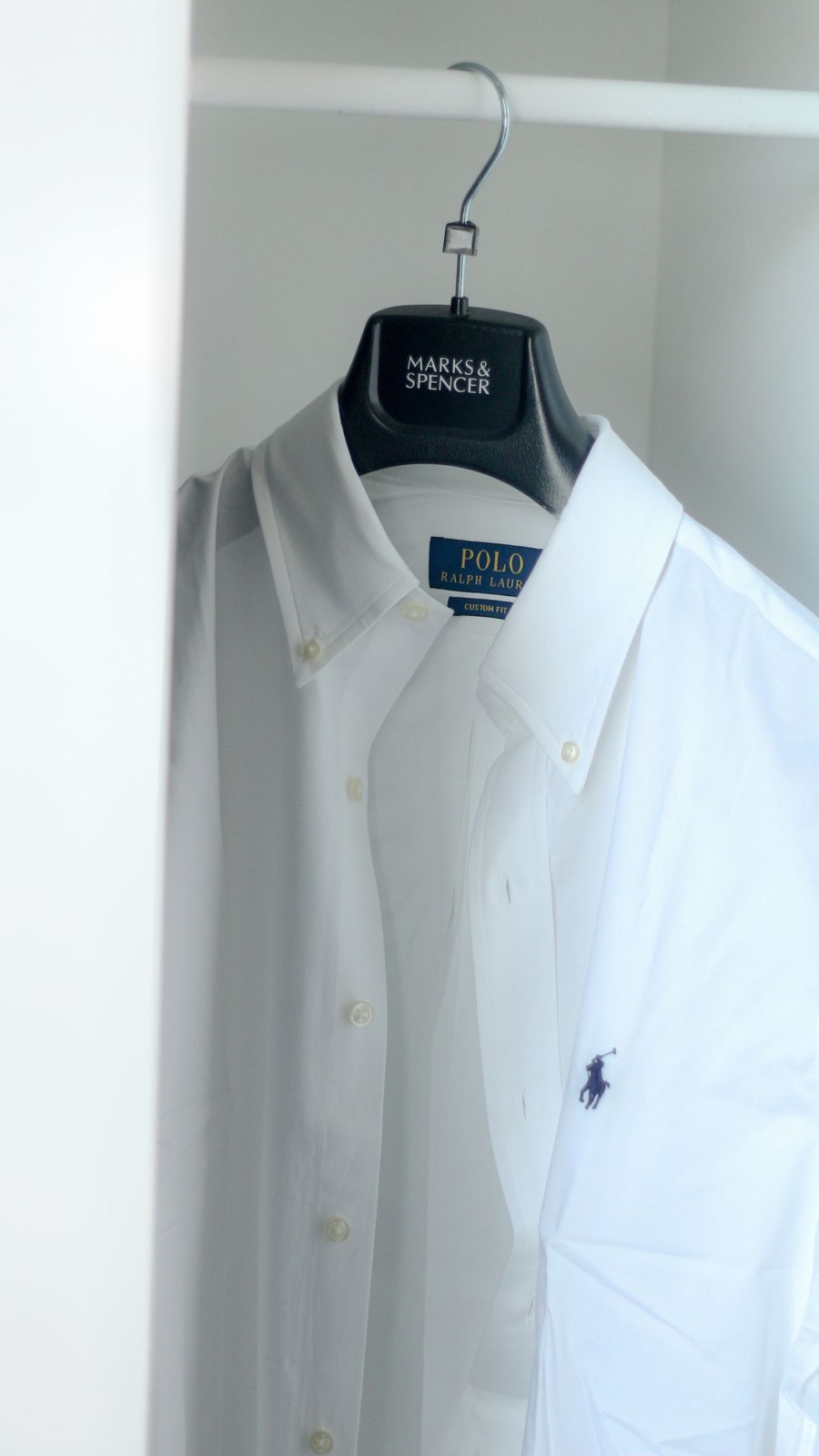 A white button-down shirt on a hanger