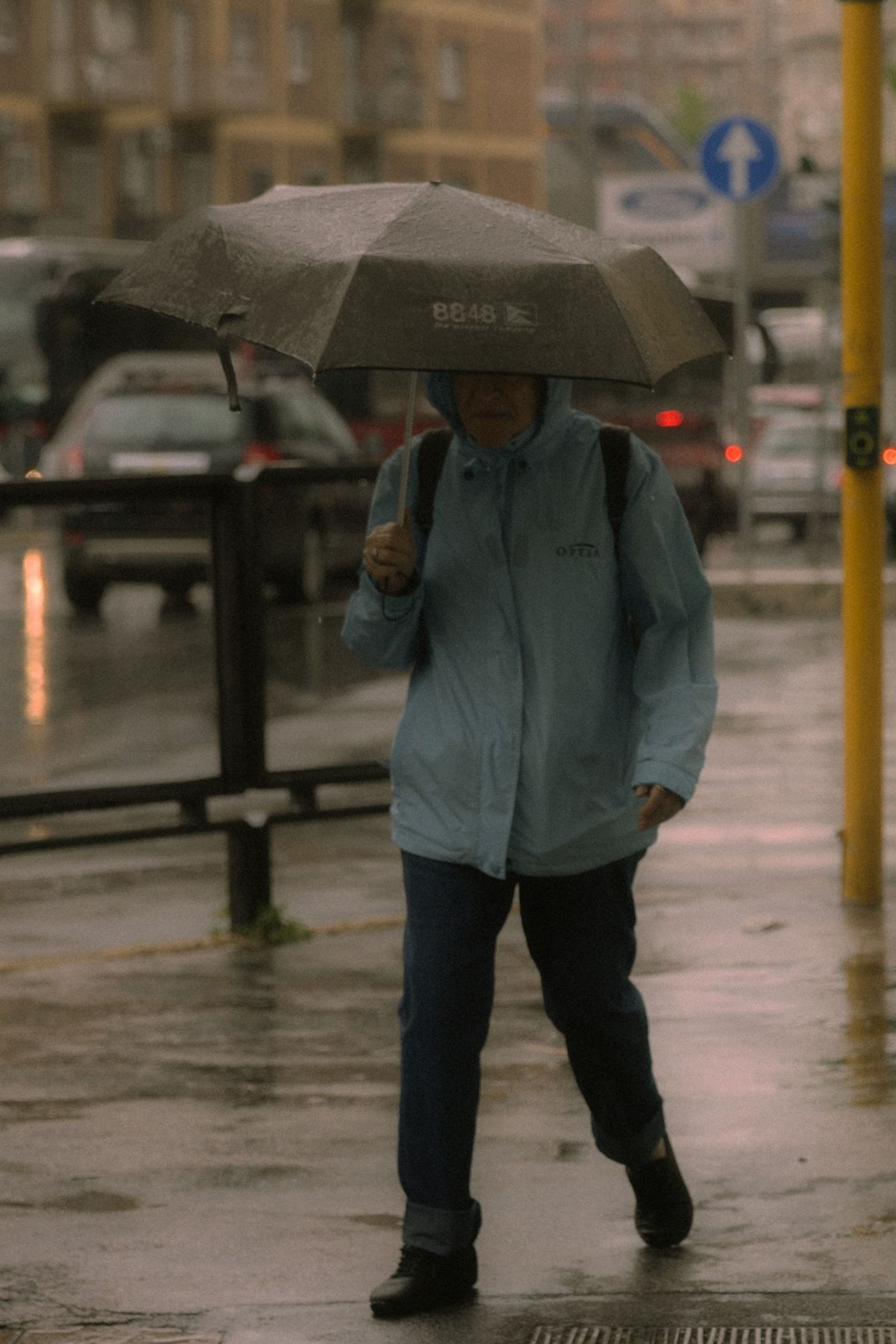 A coat and umbrella on a rainy street
