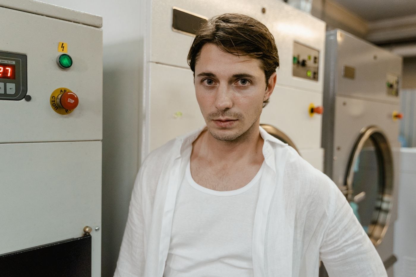 A white undershirt under an open pale shirt
