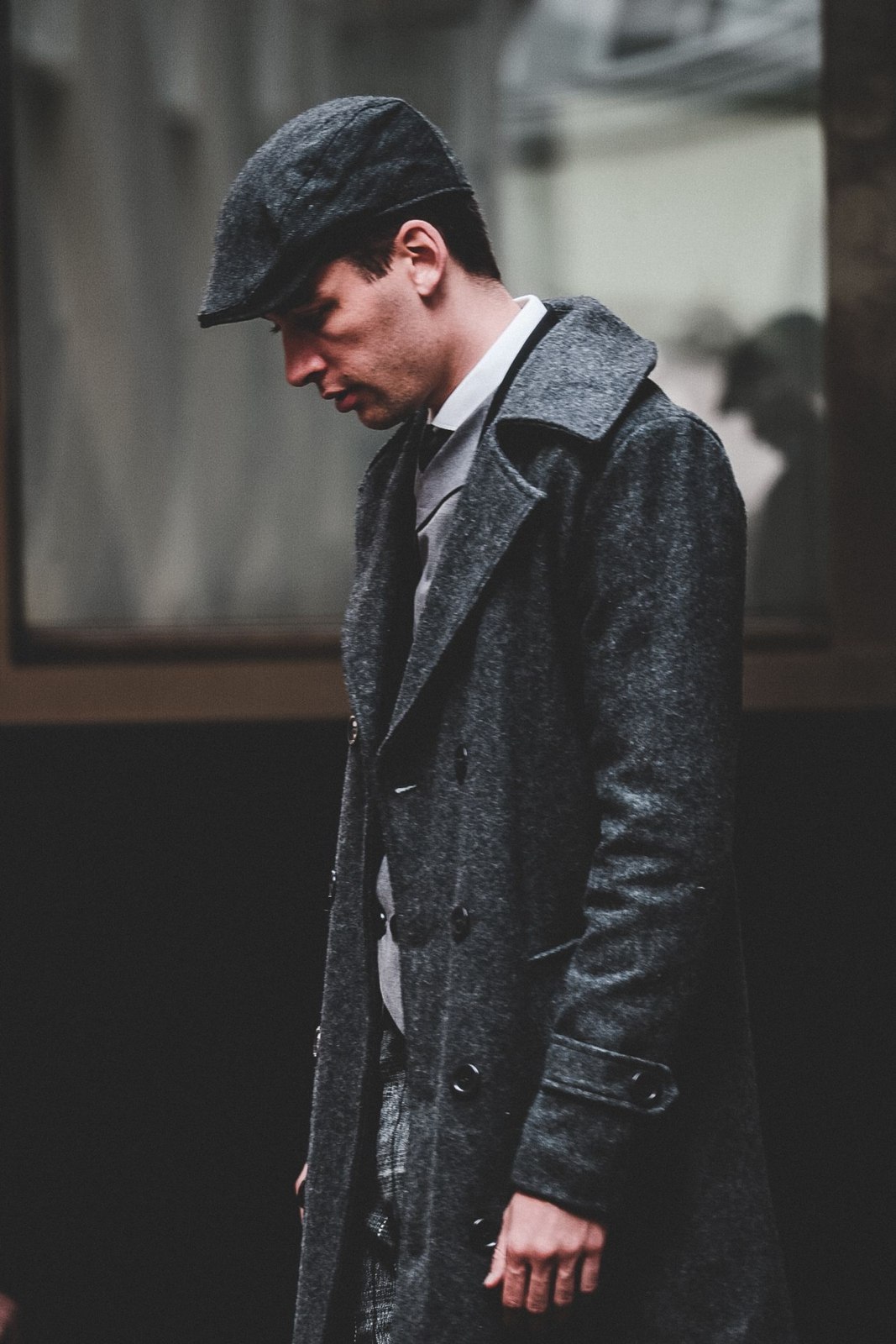 A dark overcoat layered over a jacket