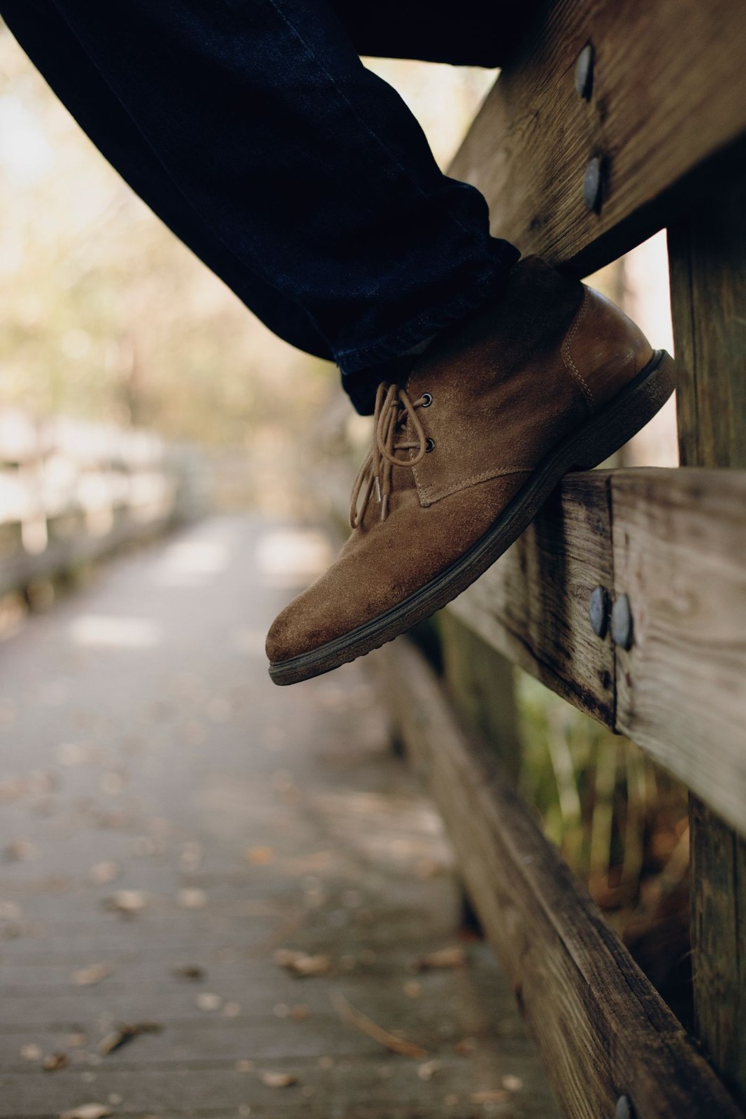 Brown footwear beneath dark navy trousers