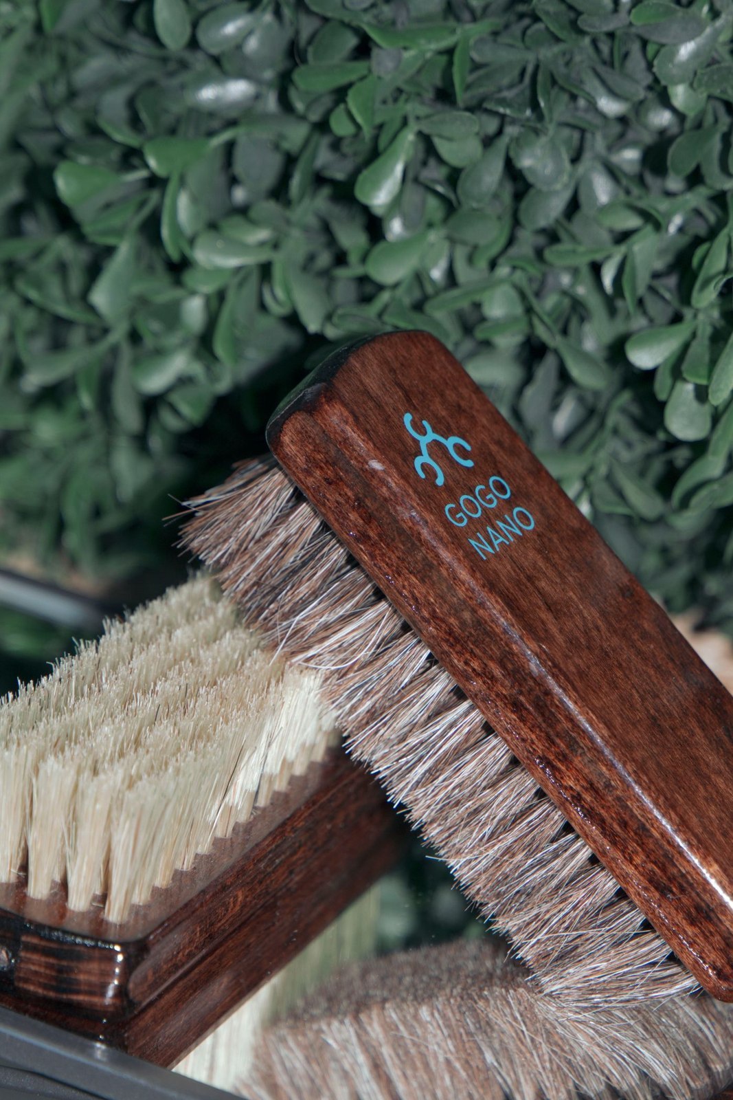 A wooden shoe brush with soft bristles