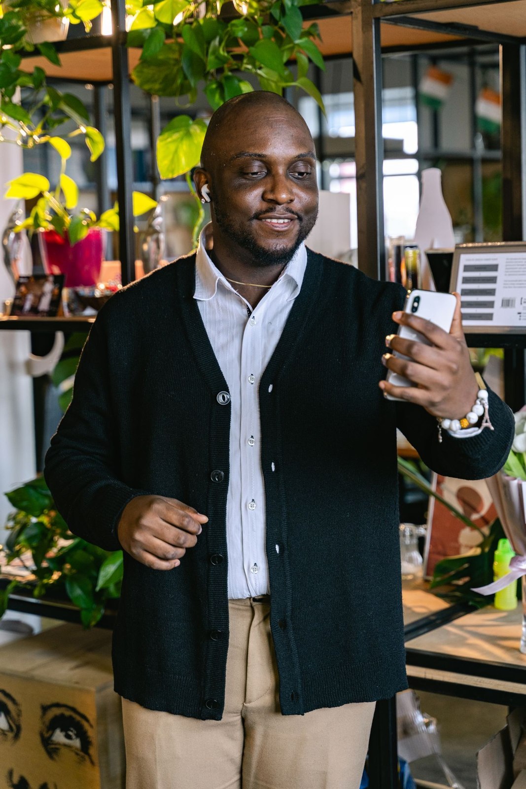 A dark navy cardigan with stone trousers