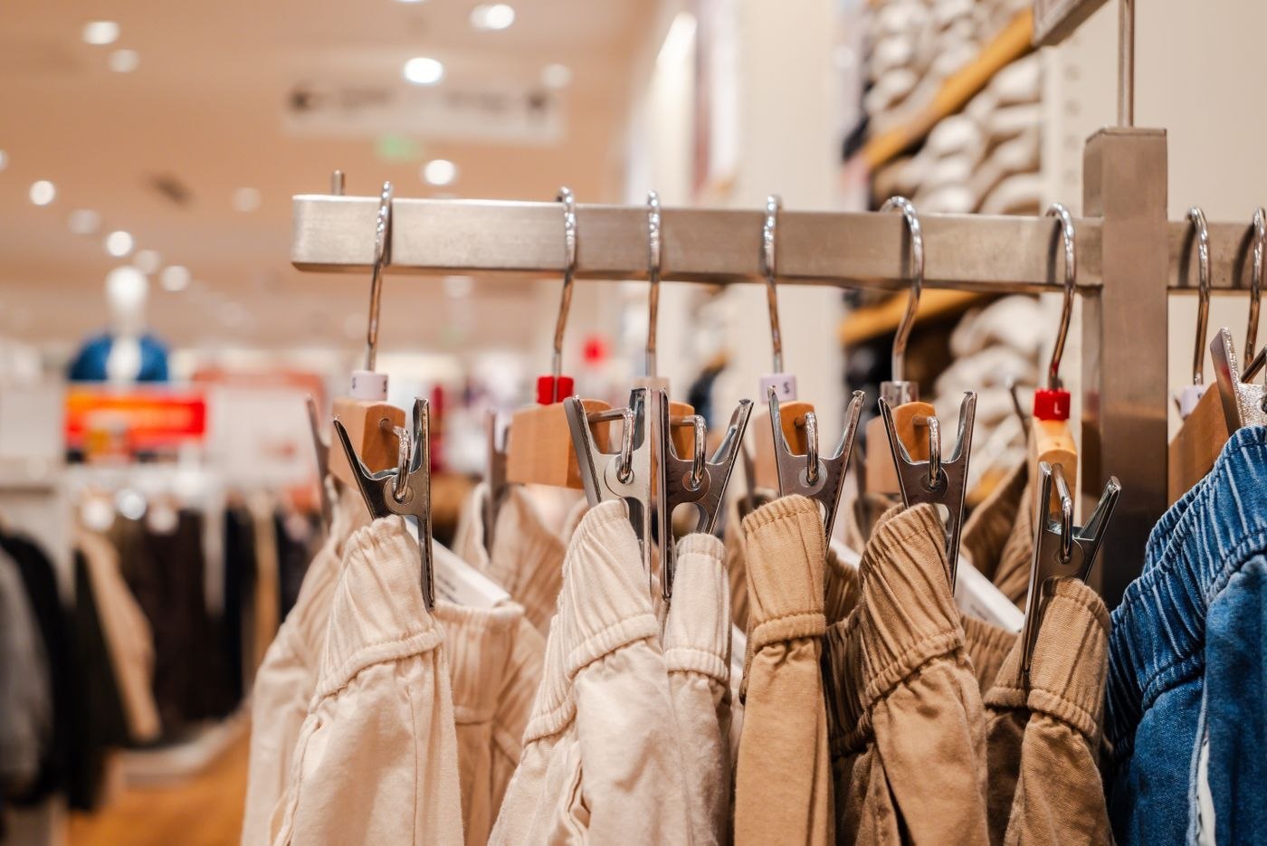 Trousers displayed on a clothing rail