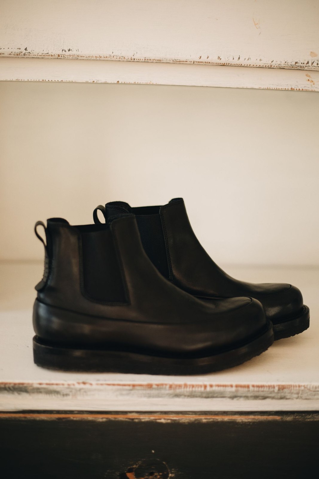 A pair of black leather Chelsea boots