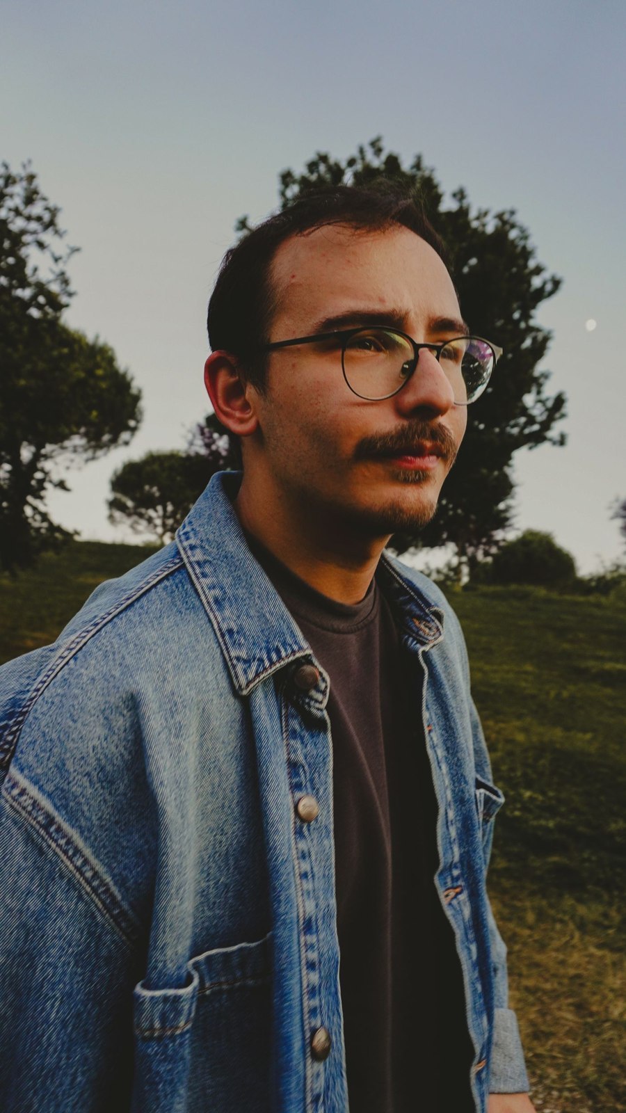 A roomy blue denim jacket worn open