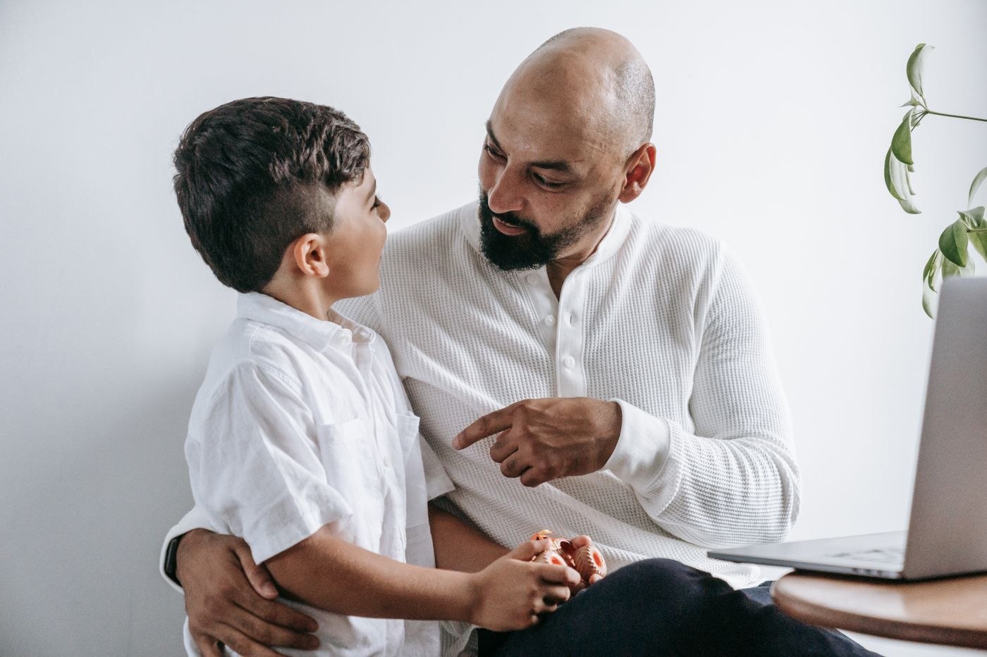 A father and child wearing light shirts