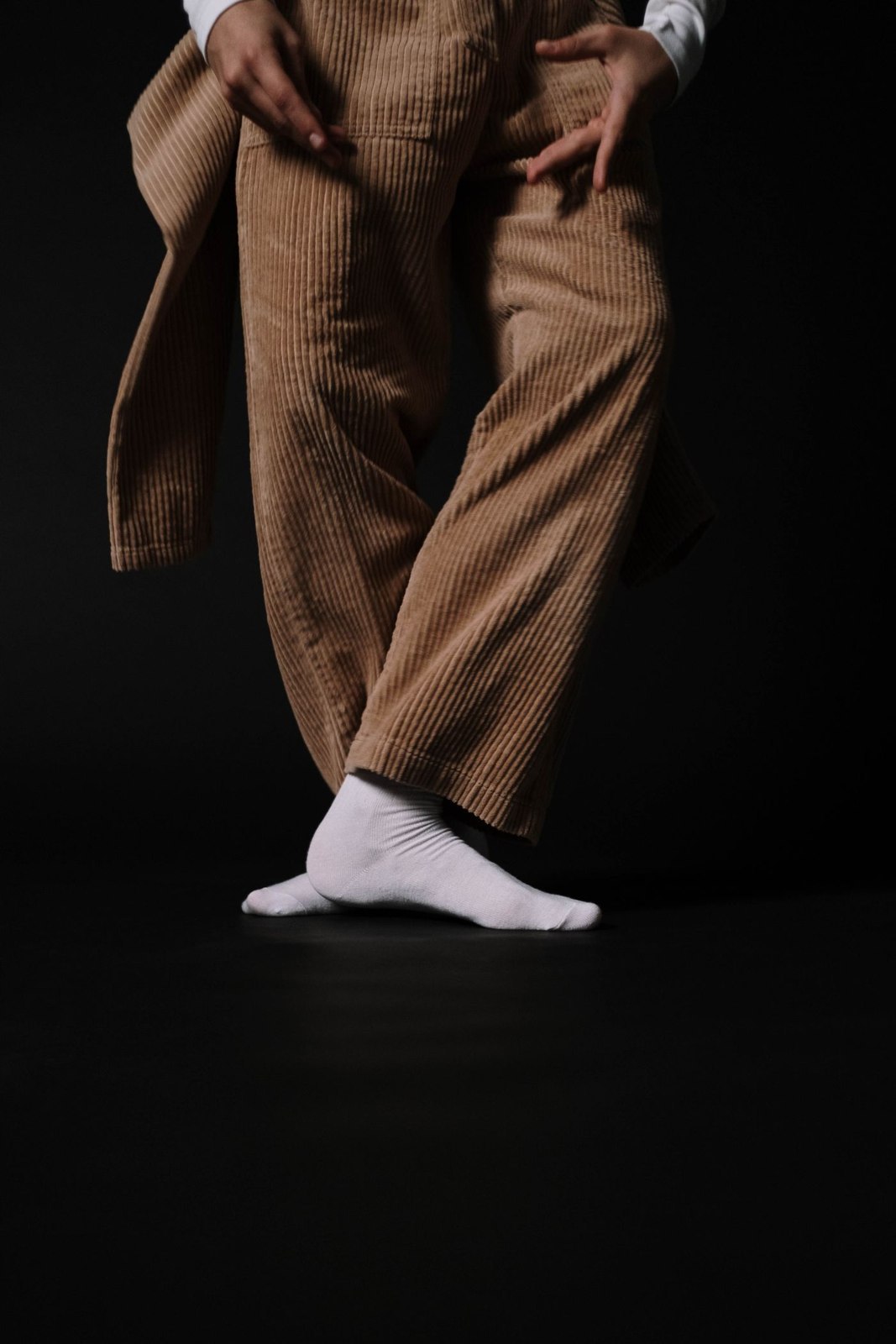 Brown corduroy trousers with dark outerwear