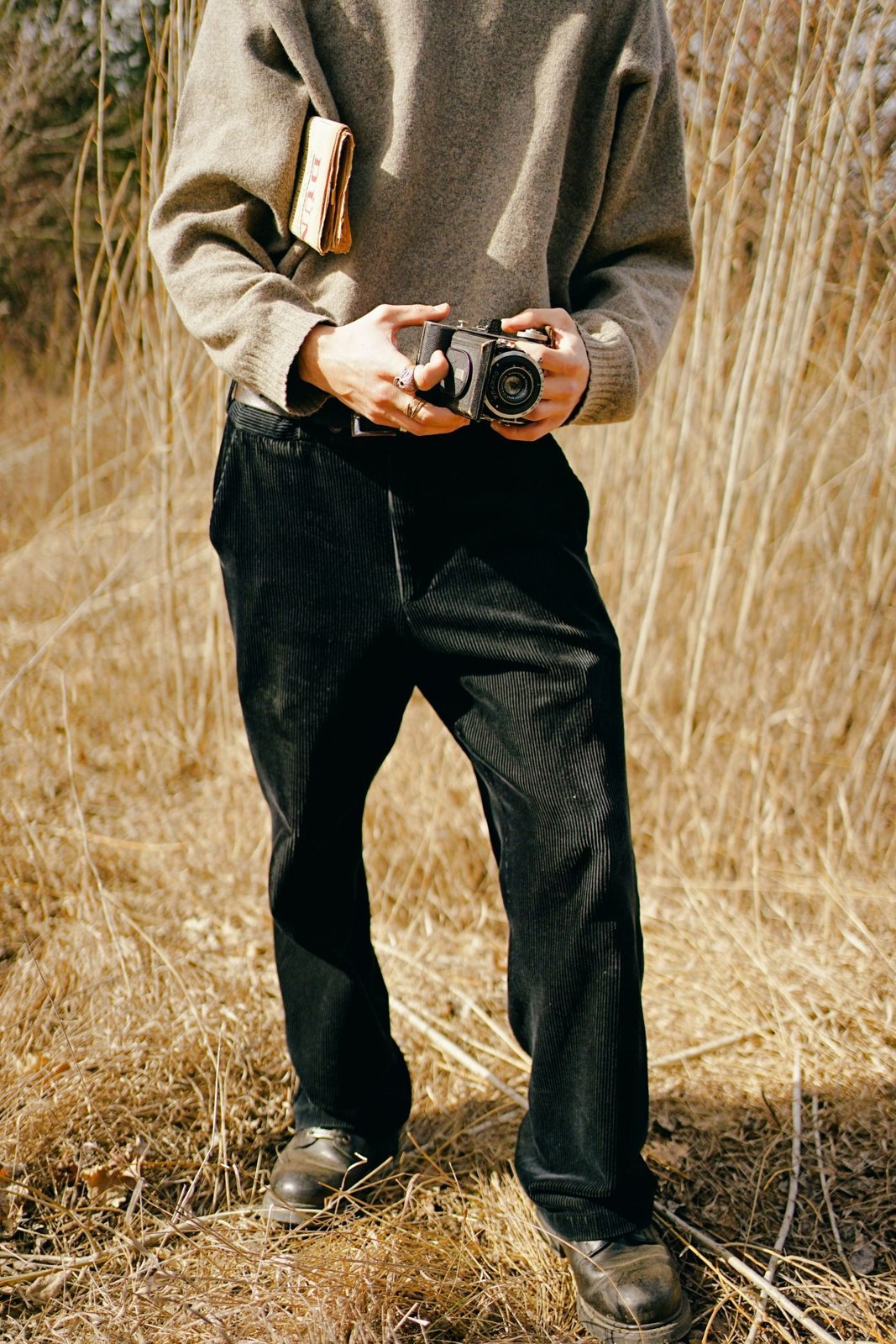A warm-toned knit with black trousers