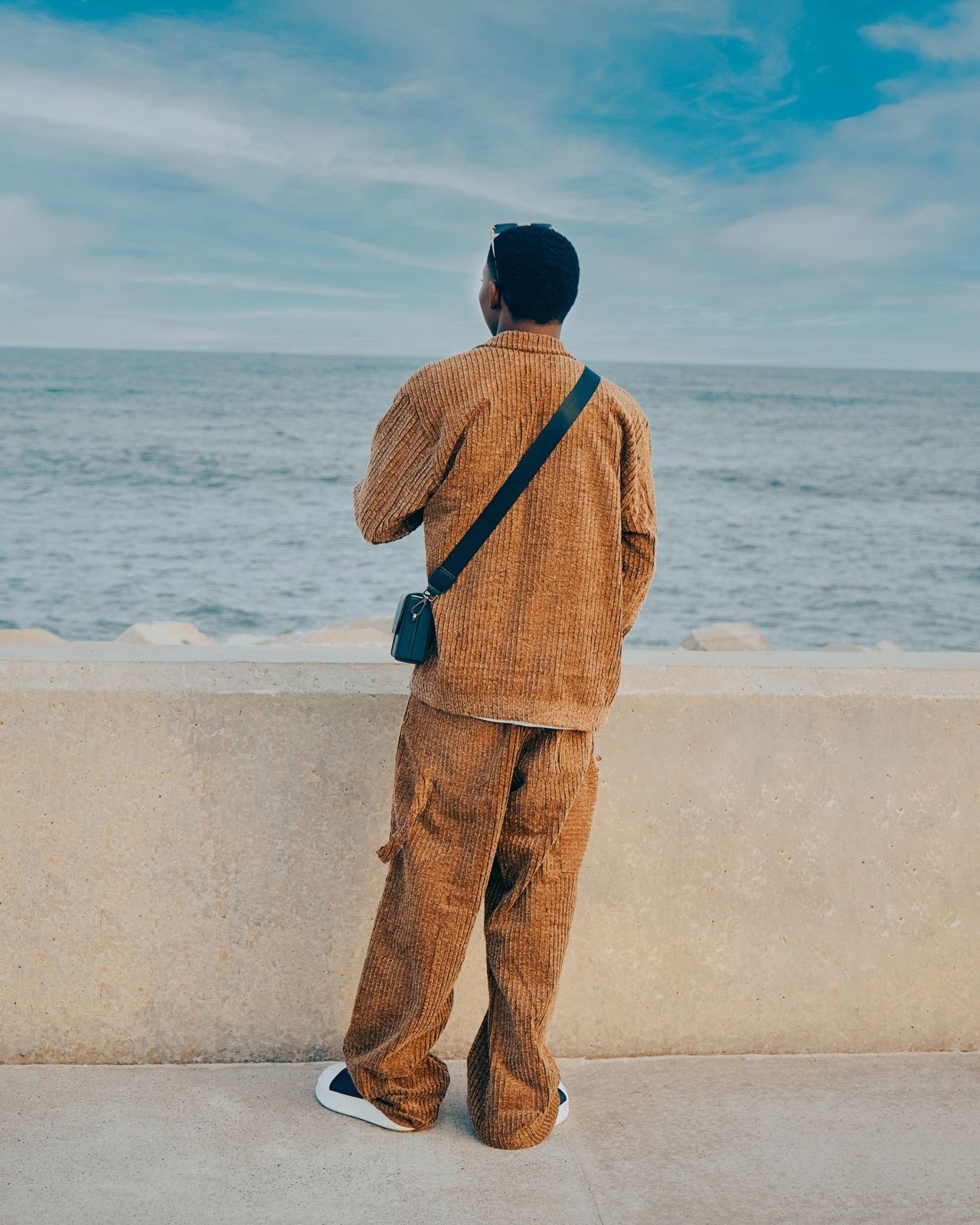 Brown corduroy trousers by the sea