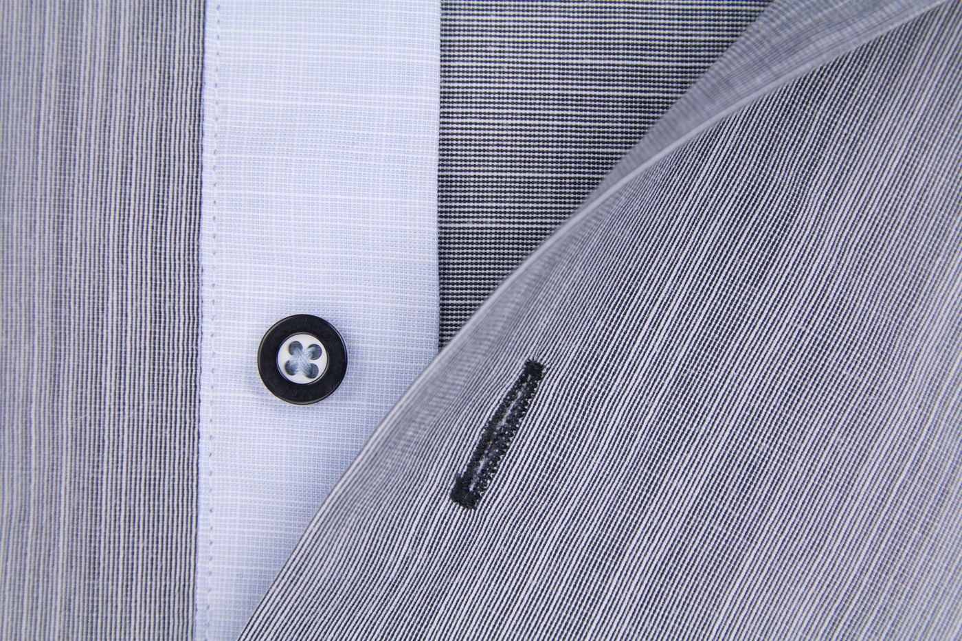 Close view of a woven shirt and buttons