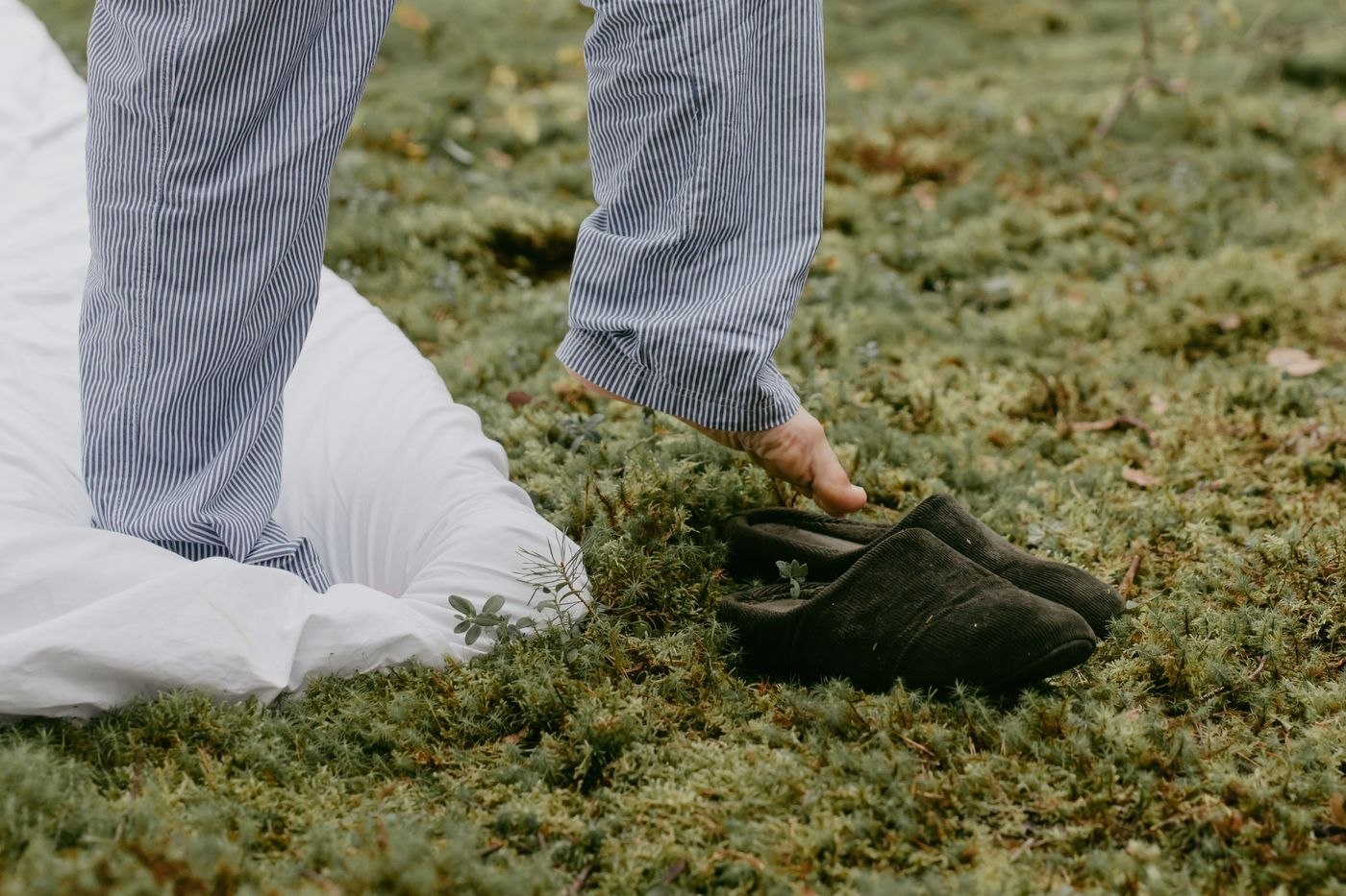 Soft house shoes worn with loose trousers