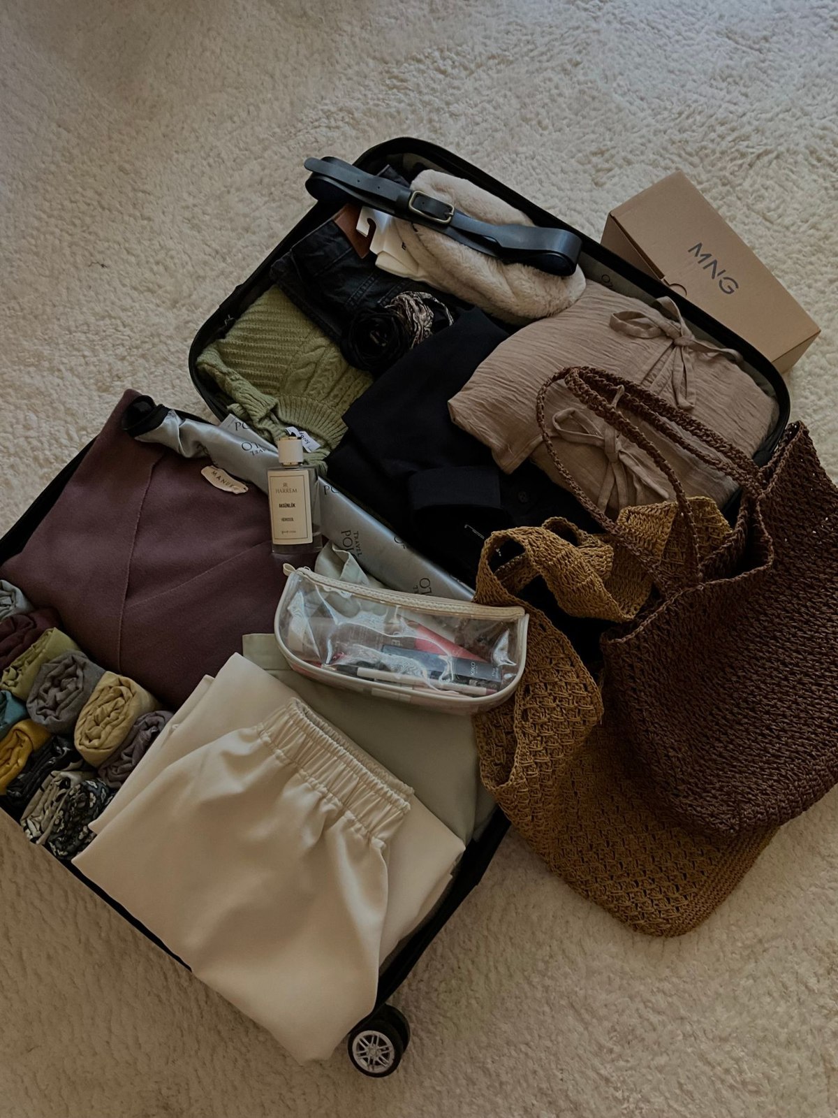 Coordinated neutral clothing packed for travel