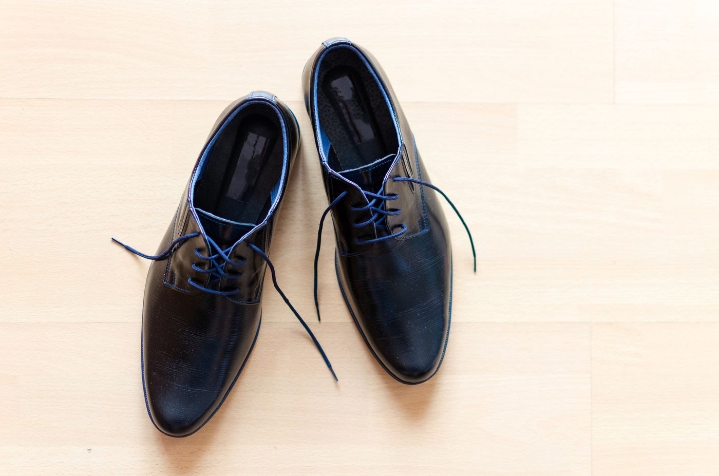 A pair of unworn black lace-up shoes