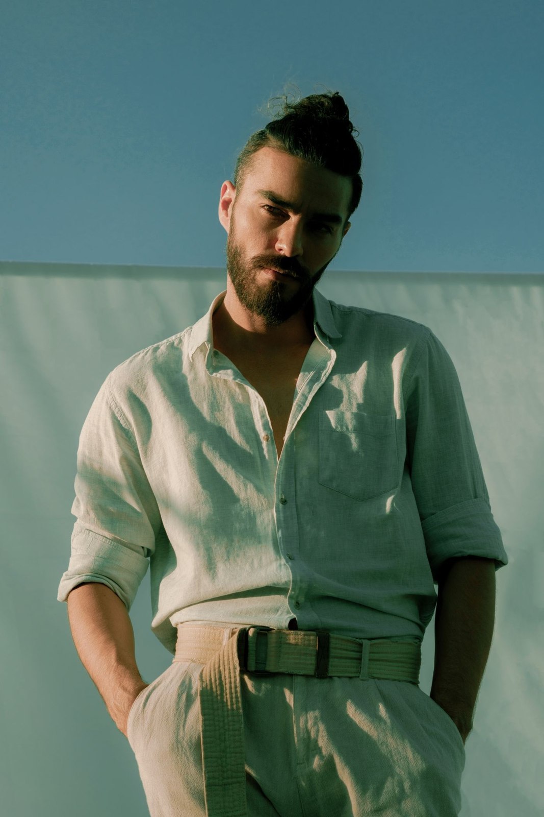 A light shirt tucked into pleated trousers