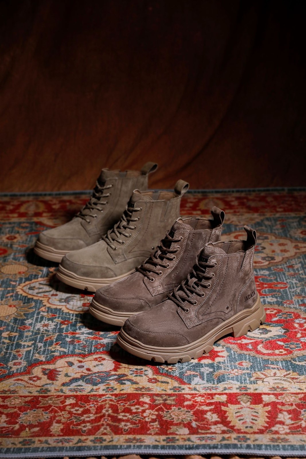 A pair of brown suede lace-up boots