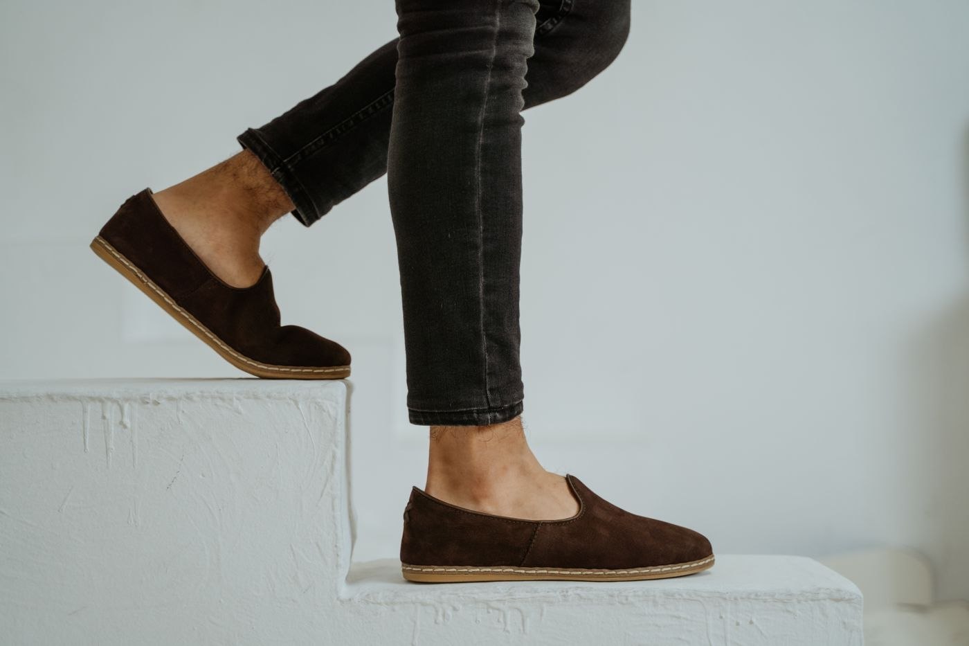 Brown suede loafers with bare ankles