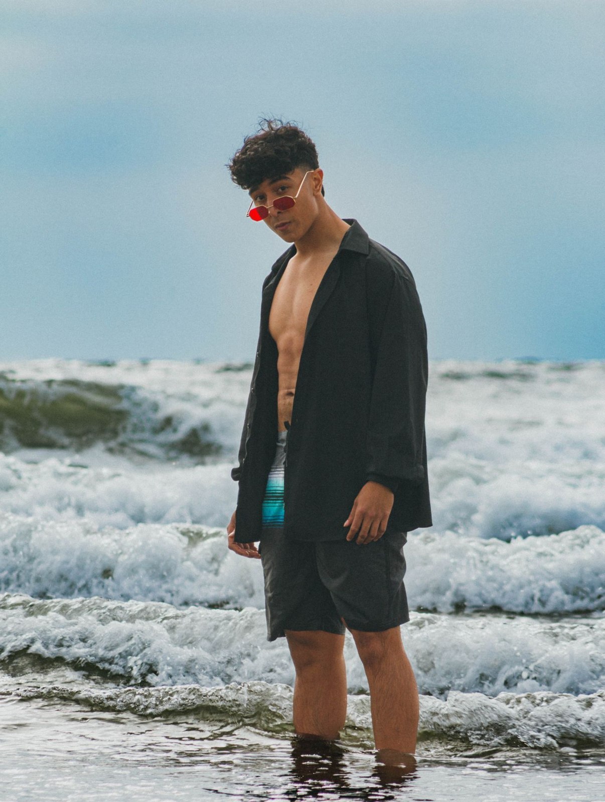 An open shirt worn over swim shorts at the sea