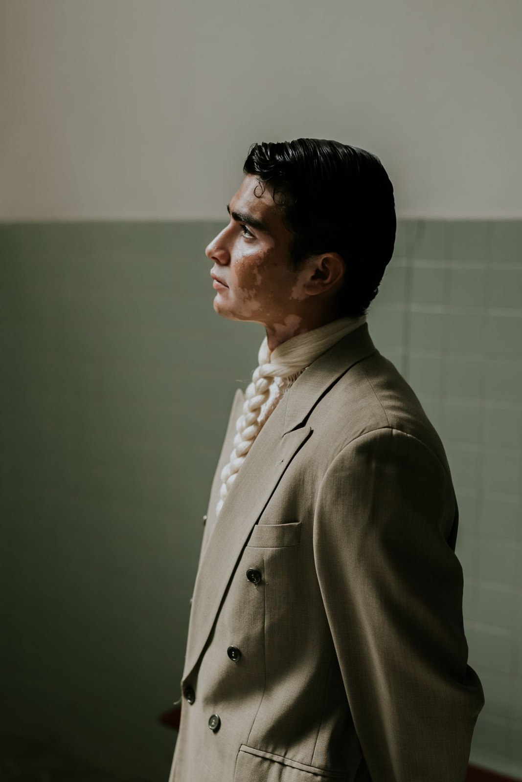 A relaxed olive jacket over a light shirt