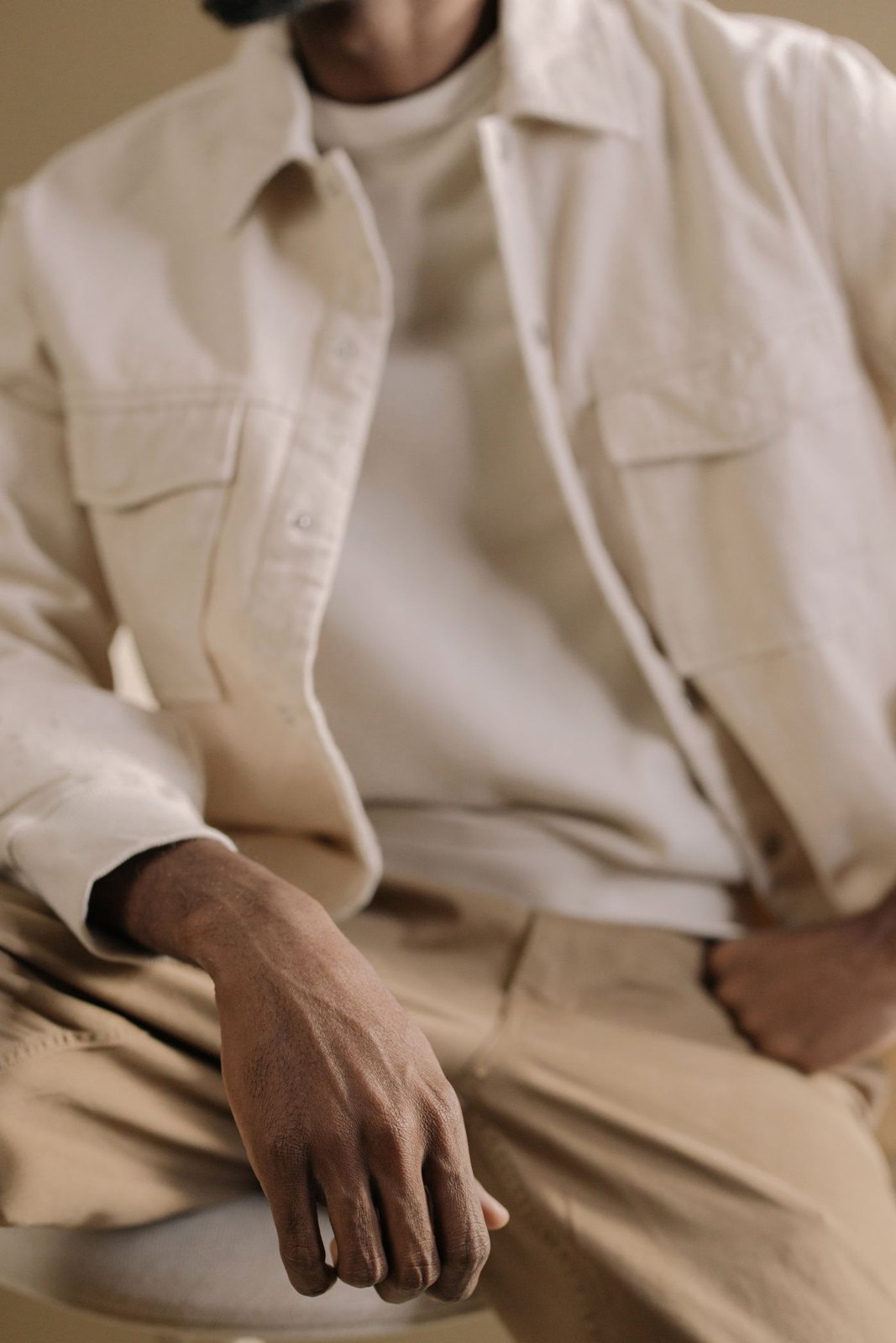 A pale overshirt above a casual top