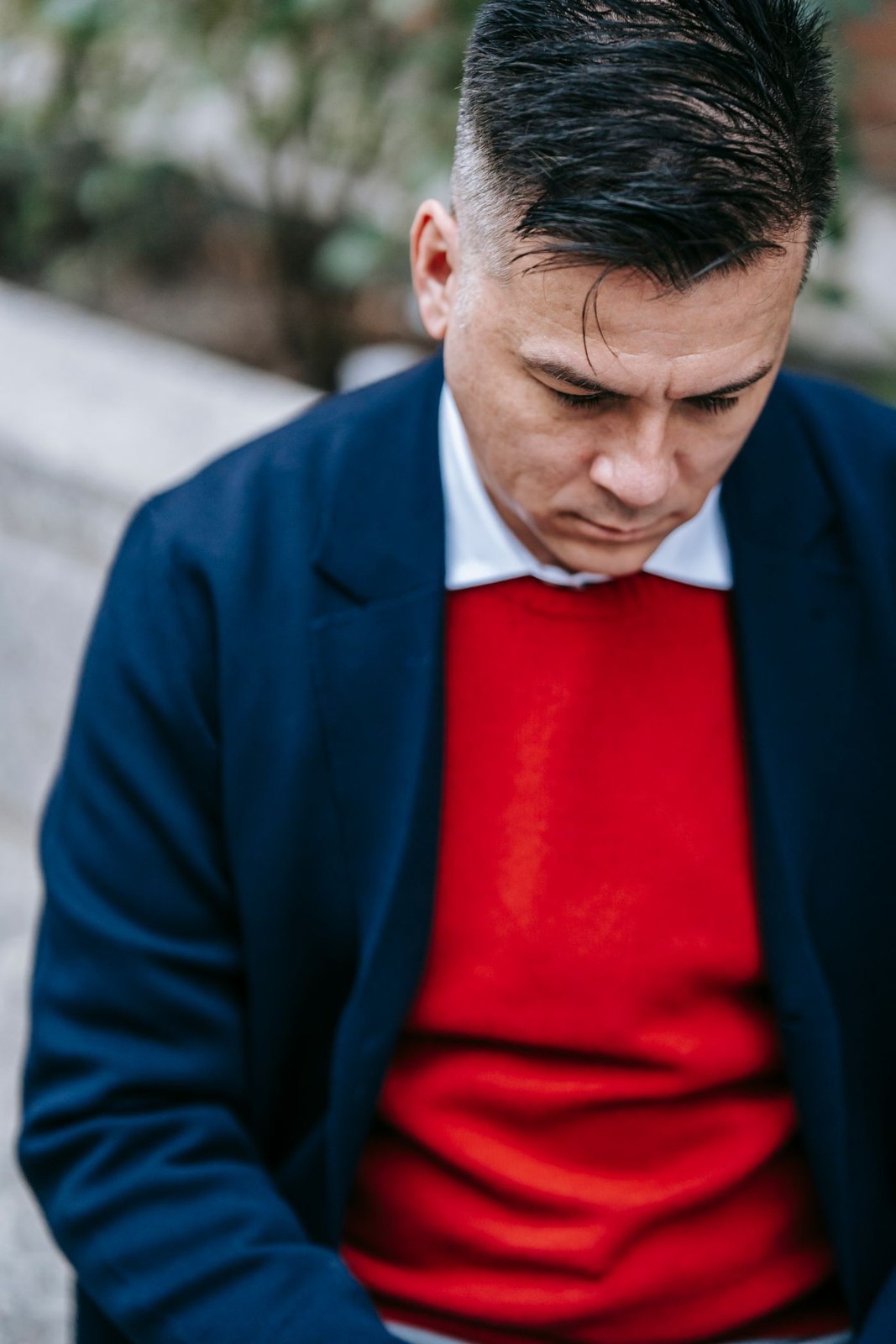 A red jumper beneath a dark blue coat