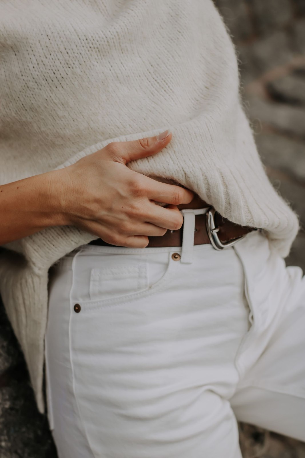 Pale knitwear and off-white trousers