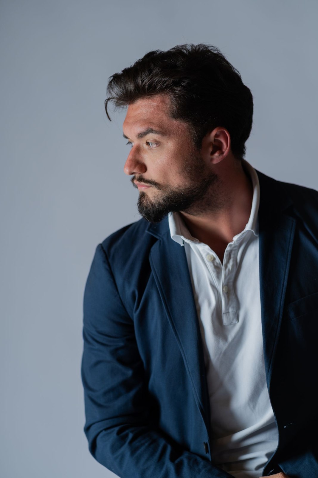 Navy jacket and open-collar white shirt