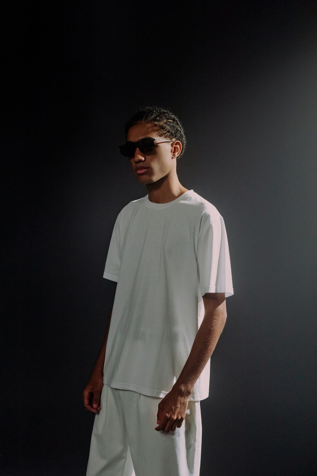 A white T-shirt worn with light pleated trousers